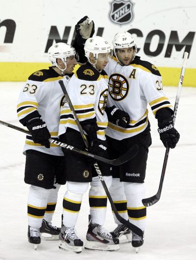 Bruins, from left, Brad Marchand, Chris Kelly and Patrice Bergeron celebrate a goal by Kelly against Columbus earlier this month. (Associated Press)