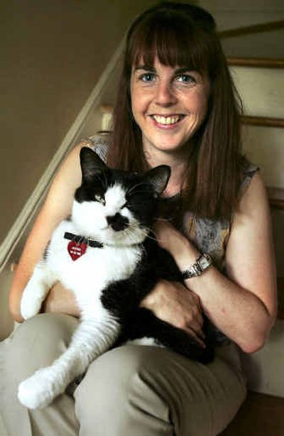 Cat-lover Sarah Stano poses in her Greensboro, N.C. home with Buster, one of her cats. Another of Stano's cats, Hereford, froze to death on a flight in November 2003. 
 (Associated Press / The Spokesman-Review)