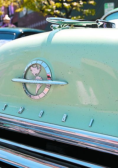 A 1954 Oldsmobile is adorned with an oversized emblem of the Western Hemisphere on the front of the hood and a rocket ship is perched  above  at the Car d’Lane classic car show last weekend. 
