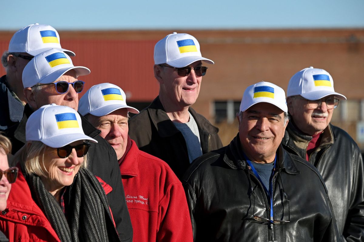 Volunteer drivers pose for a group photo after they drove reconditioned ambulances from Harrisonburg, Virginia to the Port of Baltimore so they could be shipped to Ukraine.  (Lloyd Fox/The Baltimore Sun/TNS)