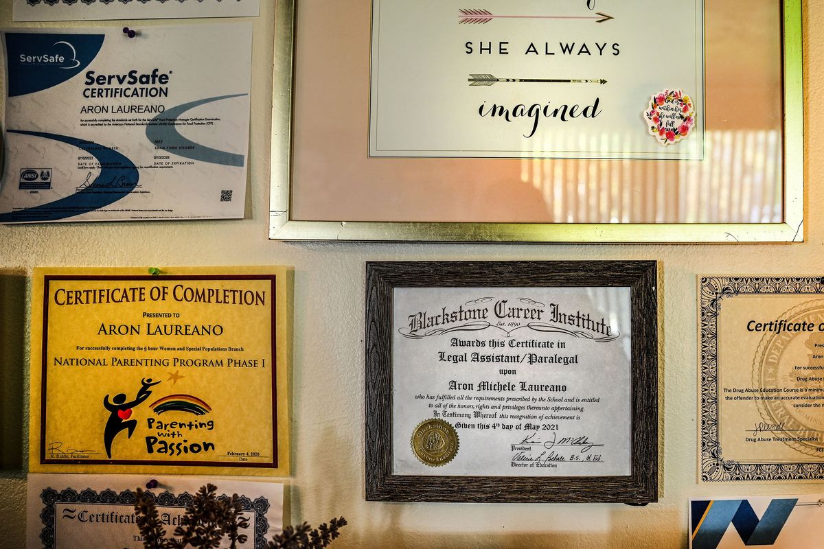 Aron Laureano’s wall is covered with certificates she earned while incarcerated. She has filed a federal complaint because she was repeatedly sexually assaulted while in federal prison in FCI Dublin in California. She talked about the experience at her home in Spokane on Thursday, September 26, 2024. She was in prison stemming from drug charges. The prison has since shut down because the guards and warden systematically sexually assaulted/abused female inmates.  (Kathy Plonka/The Spokesman-Revie)