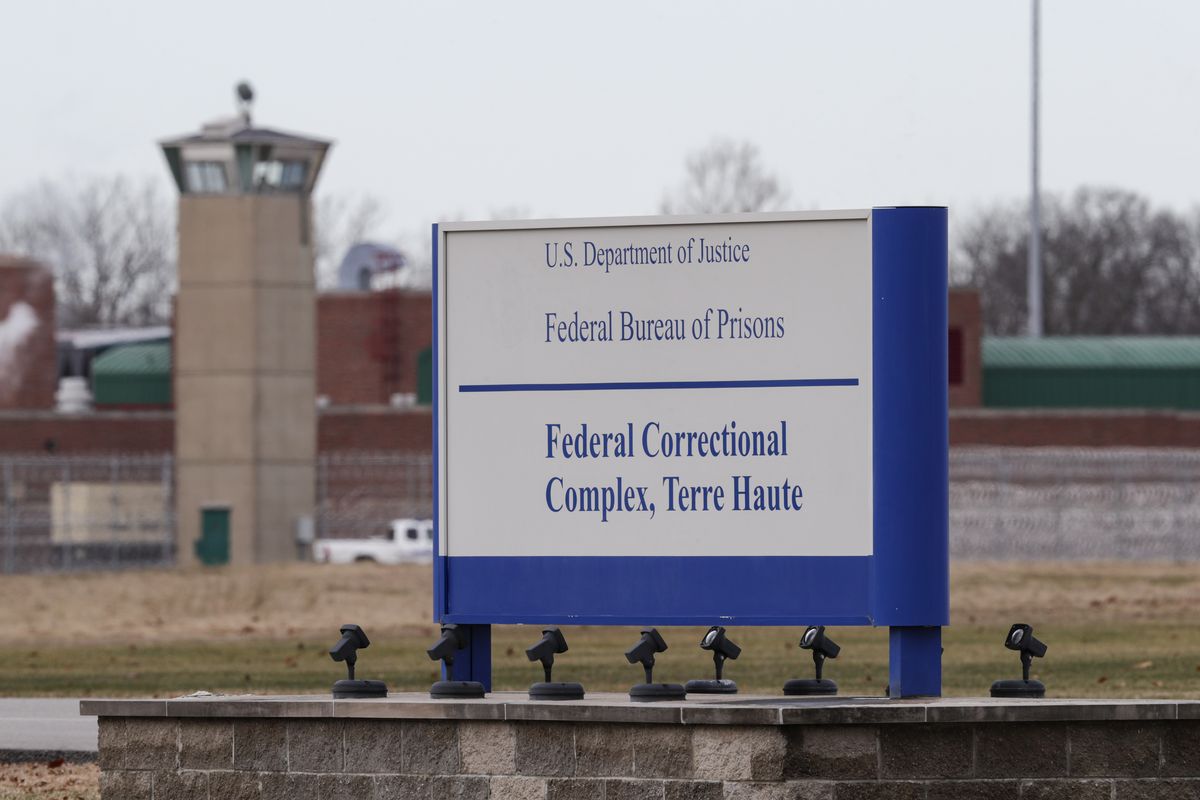 FILE - In this Dec. 10, 2019, file photo the guard tower flanks the sign at the entrance to the U.S. Penitentiary in Terre Haute, Ind. The Justice Department plans to resume federal executions next week for the first time in more than 15 years, despite the coronavirus pandemic raging both inside and outside prisons and stagnating national support for the death penalty. Three people are slated to die by lethal injection in one week beginning Monday. The executions will take place at USP Terre Haute.  (Michael Conroy)