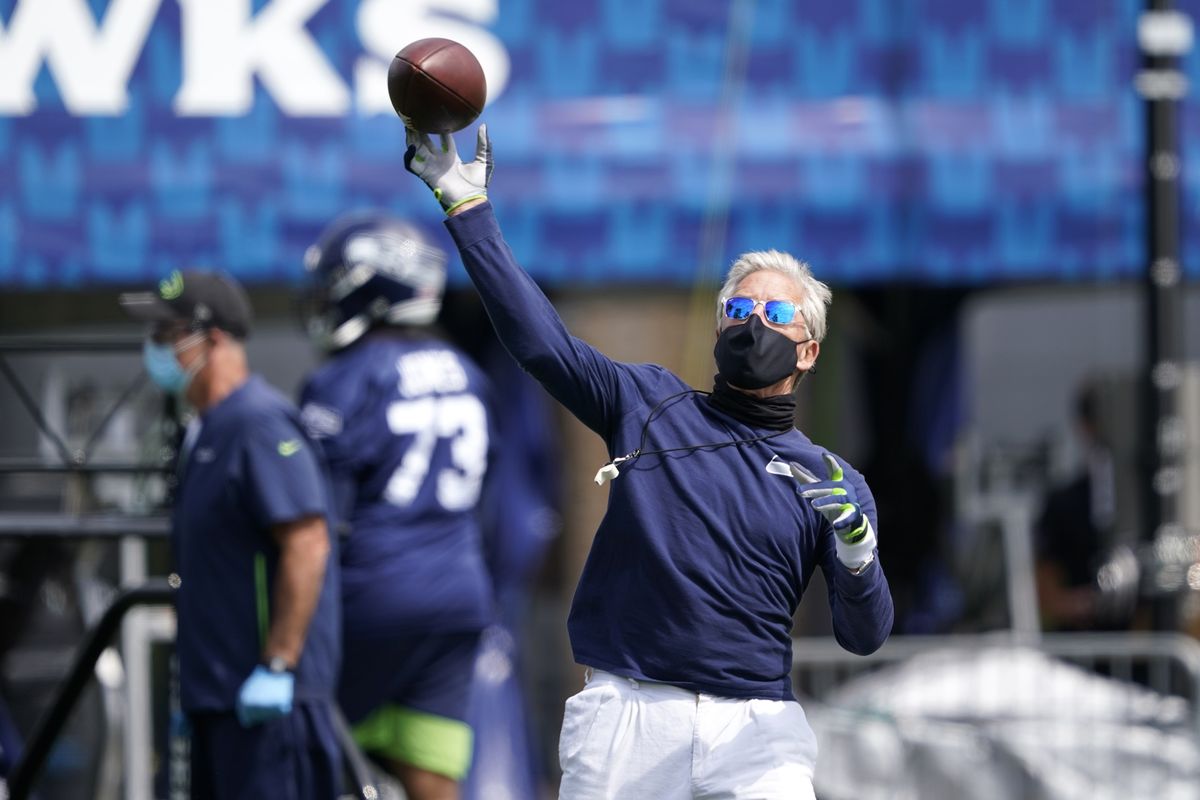 Seattle Seahawks head coach Pete Carroll throws a football during NFL football training camp, Wednesday, Aug. 12, 2020, in Renton, Wash.  (Associated Press)