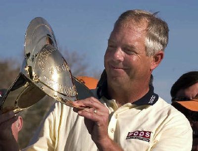 Kirk Triplett holds the conquistador helmet he received for winning the Chrysler Classic. 
 (Associated Press / The Spokesman-Review)