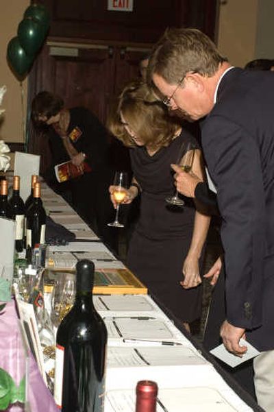 
Guests bid on wines and other specialty gifts held at the gala's silent auction. Photo courtesy of Michael Hardenbro
 (Photo courtesy of Michael Hardenbro / The Spokesman-Review)