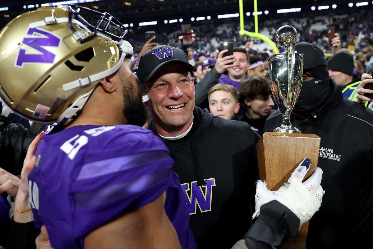 Washington head coach Kalen DeBoer celebrates with offensive lineman Troy Fautanu after defeating Washington State 24-21 to capture the 115th Apple Cup at Husky Stadium on Nov. 25 in Seattle. Despite the rivalry, many Cougar fans will be cheering for the Huskies against Michigan during Monday’s national championship game.  (Tribune News Service)