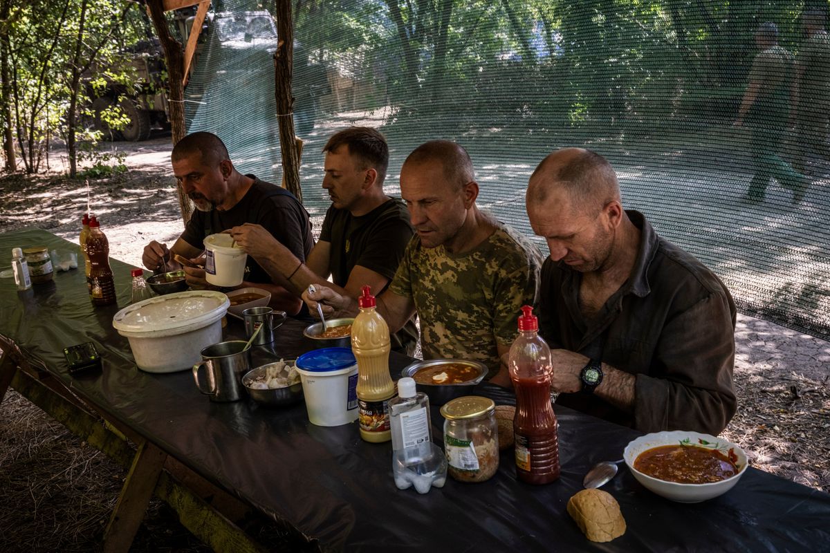 Troops from the 47th have a lunch of borscht after working on Bradley Fighting Vehicles at the Zaporizhzhia workshop.  (Ed Ram/for The Washington Post)