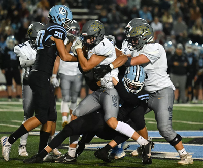 Central Valley defensive back Kamden Lanphere tries to tackle Mead wide receiver Max Workman (1) during the first half of a GSL high school football game, Friday, September 30, 2022, at Central Valley High School.  (Colin Mulvany/The Spokesman-Review)