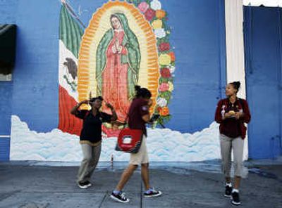 
Pedestrians pass by a mural in the Florence- Firestone neighborhood of Los Angeles County, where, according to investigators, leaders of the Florencia 13 Latino gang ordered killings based on race.  Associated Press
 (Associated Press / The Spokesman-Review)