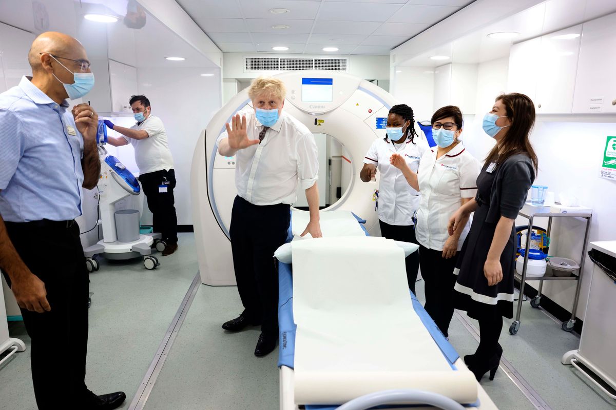 Britain’s Prime Minister Boris Johnson, centre, gestures, during a visit to Finchley Memorial Hospital, in North London, Tuesday, Jan. 18, 2022.  (Ian Vogler)