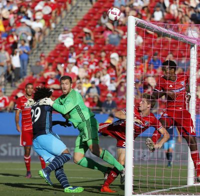 Sounders defender Roman Torres (29) collides with FC Dallas keeper Chris Seitz on a corner kick. (Tony Gutierrez / Associated Press)
