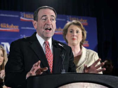 
Republican presidential hopeful  Mike Huckabee is joined by his wife, Janet, at a victory party Thursday in Des Moines, Iowa.Photos by Associated Press
 (Photos by Associated Press / The Spokesman-Review)