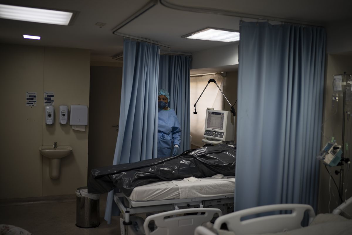 The body of a COVID-19 victim lies in a body bag at the ICU of the Sao Jose municipal hospital in Duque de Caxias, Brazil, Wednesday, March 24, 2021.  (Felipe Dana)