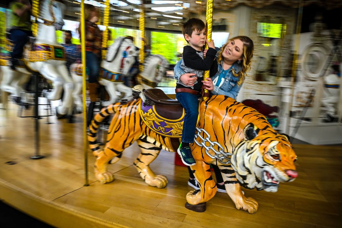 Adrianna Sampey hangs on tight to her son Archer, 5, as they take spin on the Looff Carrousel on Sunday in Spokane’s Riverfront Park during the Rosalie Murrey Foundation’s sensory-friendly event for kids with disabilities who may otherwise be overwhelmed by sights and sounds. (DAN PELLE/FOR THESPOKESMAN-REVIEW)