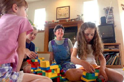 
Carlyn Shaffer, second from right, is the Kootenai County Family Care Provider of the Year. She runs her own preschool and day care at her home. At left are her two children, Grace, 6, and Travis, 8, who both went through her preschool program, and at right is Madison Lyman, 5, who is currently enrolled. 
 (Jesse Tinsley / The Spokesman-Review)