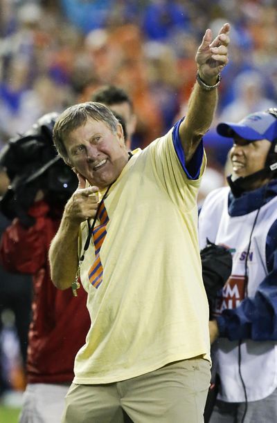 Former Florida player and head coach Steve Spurrier imitated Usain Bolt when he was honored during Saturday’s game  in Gainesville, Florida. (John Raoux / Associated Press)