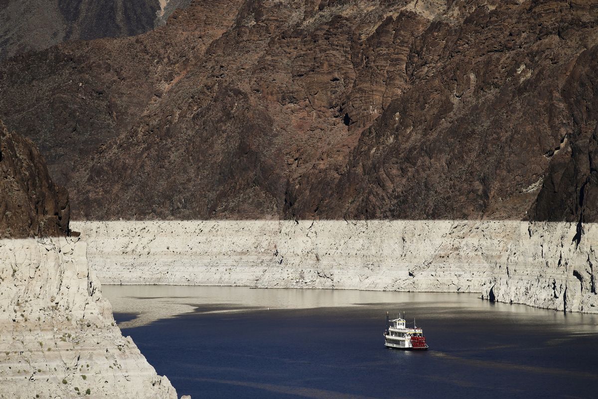 In this Oct. 14, 2015 photo, a riverboat glides through Lake Mead on the Colorado River at Hoover Dam near Boulder City, Nev. The Bureau of Reclamation is forecasting first-ever water shortages because of falling levels at Lake Mead and says the reservoir could drop so low that it might not be able to generate electricity at Hoover Dam.  (Jae C. Hong)