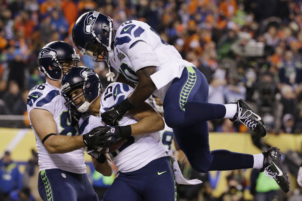 Seahawks’ Jermaine Kearse, center, celebrates with Zach Miller, left, and Derrick Coleman, after catching a 23-yard touchdown pass in the second half. (Associated Press)