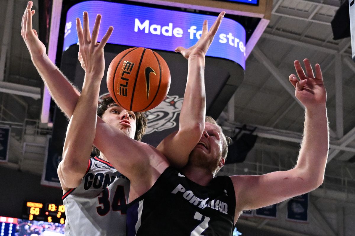 Gonzaga Bulldogs forward Braden Huff (34) rebounds the ball against Portland Pilots guard Tyler Robertson (2) during the second half of a college basketball game on Wednesday, Feb. 7, 2024, at McCarthey Athletic Center in Spokane, Wash. Gonzaga won the game 96-64.  (Tyler Tjomsland/The Spokesman-Review)