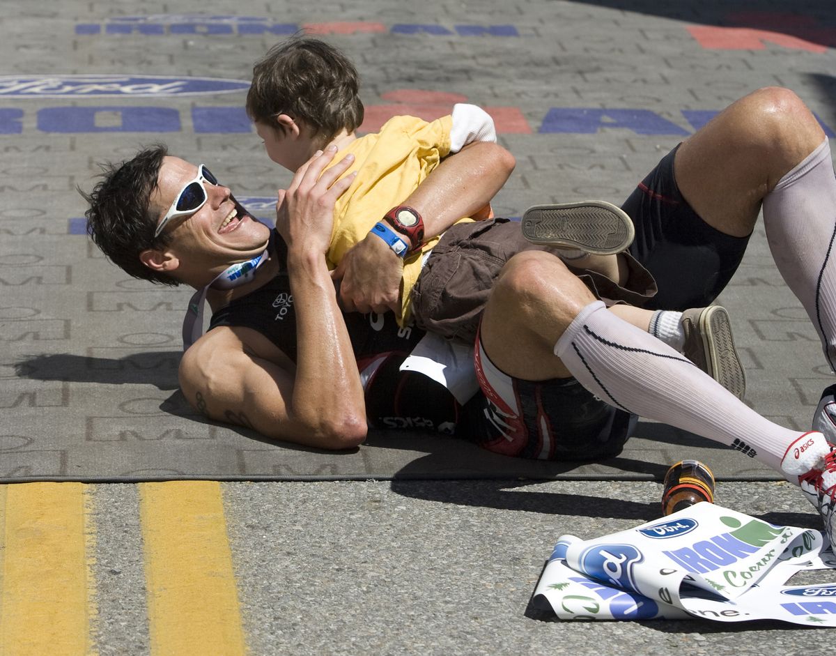 Men’s Ironman winner Andy Potts celebrates with his 3-year-old son, Boston.