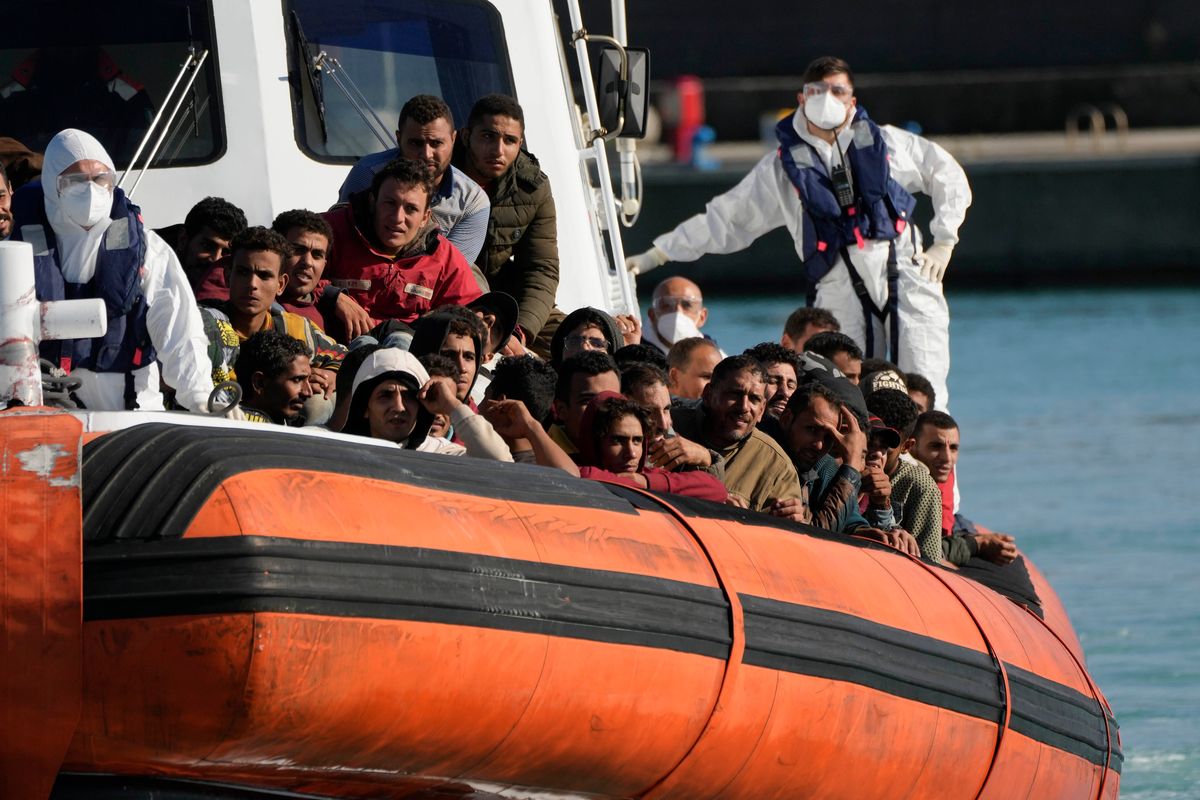 Migrants and refugees enter in the port of Roccella Jonica, Calabria region, southern Italy, Sunday, Nov. 14, 2021. The Italian Coast Guard rescued Sunday morning off the cost Calabria over 250 young men and boys, mostly from Egypt. (Alessandra Tarantino)
