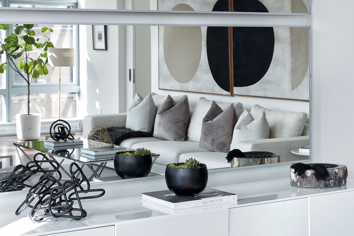 Mirrors above a long sideboard help reflect decorative accessories.  (Scott Gabriel Morris)