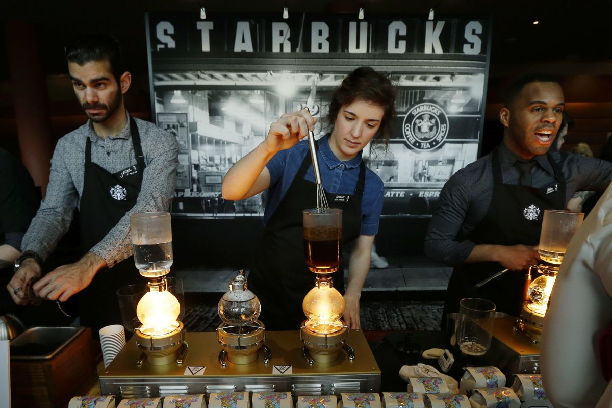 In this Wednesday, March 23, 2016, file photo, Starbucks workers prepare coffee  at a station in the lobby of the coffee company’s annual shareholders meeting in Seattle. (Ted S. Warren / Associated Press)