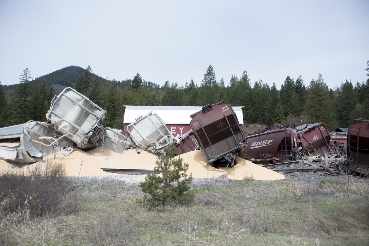 As many as a dozen train cars, filled with corn, lie along U.S. Highway 95 in the Cocollalla area north of Coeur d’Alene, Monday, May 1, 2017, where they derailed in the early morning hours. No one was hurt and BNSF crews were on scene quickly. (Jesse Tinsley / The Spokesman-Review)