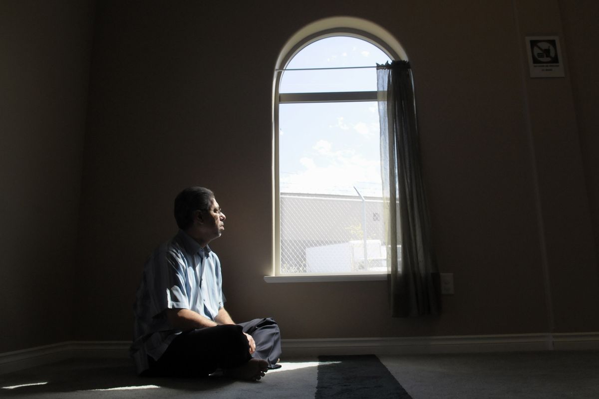 Mamdouh El-Aarag reflects in the prayer room of the Islamic Center in Spokane Valley on Aug. 26. (Christopher Anderson)