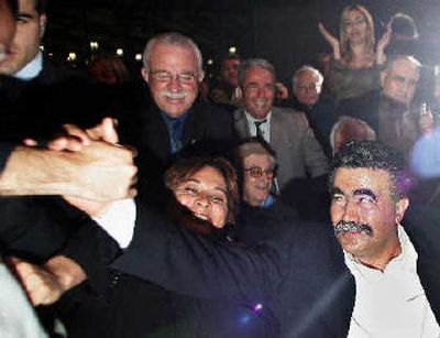 
The new leader of Israel's Labor Party, Amir Peretz, is greeted upon his arrival at a Labor Party convention in Tel Aviv, Israel, on Sunday. Israel's dovish Labor Party voted Sunday to pull out of Prime Minister Ariel Sharon's government after new Peretz charged that Sharon's policies have increased poverty.
 (Associated Press / The Spokesman-Review)
