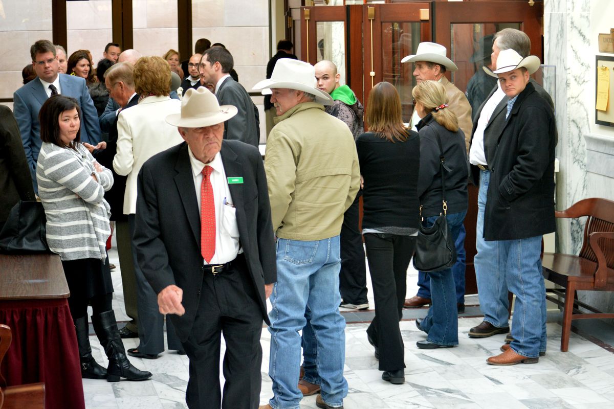 Harry Bettis, rancher and part owner of Les Bois Park in Boise, in the red tie, leaves a Senate committee hearing in Boise on Wednesday at which lawmakers voted to repeal “instant racing.” (David Goins)