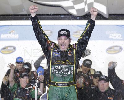 FILE - Johnny Sauter celebrates in Victory Lane after winning the NASCAR Truck Series auto race at Daytona International Speedway in February 2016. Sauter won another NASCAR Truck Series race Friday at Chicagoland Speedway. (Chuck Burton / Associated Press)