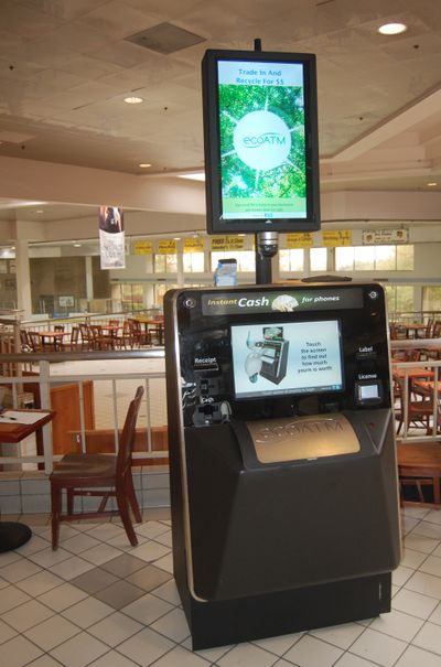 The EcoATM has a big metal “mouth” where you can place your old phone or MP3 player. (Associated Press)