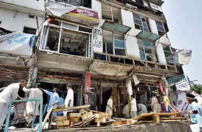 
Pakistani shopkeepers remove rubble Saturday at the site of Friday's suicide bombing in Islamabad. Associated Press
 (Associated Press / The Spokesman-Review)