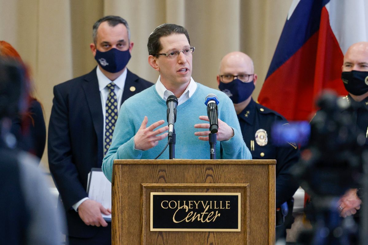 Rabbi Charlie Cytron-Walker of Congregation Beth Israel addresses reporters during a news conference at Colleyville Center on Friday, Jan. 21, 2022 in Colleyville, Texas. In the final moments of a 10-hour standoff with a gunman at a Texas synagogue, the remaining hostages and officials trying to negotiate their release took “near simultaneous plans of action,” with the hostages escaping as an FBI tactical team moved in, an official said Friday.  (Elias Valverde II)