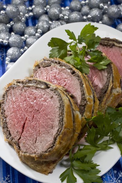 Beef Wellington uses a center-cut beef tenderloin section. Whether it's a standing prime rib, a rack of lamb or a saddle of veal, roasts can be as intimidating as they are dramatic.  (Associated Press)