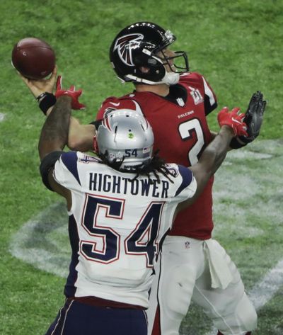 Patriots' Dont'a Hightower knocks the ball away from Atlanta Falcons' Matt Ryan for a fumble New England recovered. (Charlie Riedel / Associated Press)