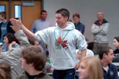 
Patrick McHail of Kootenai High School walks forward through the crowd to receive his award after he was announced as the top scorer in the small school division of the High School Mathmatics Contest. 
 (Jesse Tinsley / The Spokesman-Review)