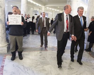 Gov. Butch Otter walks past 