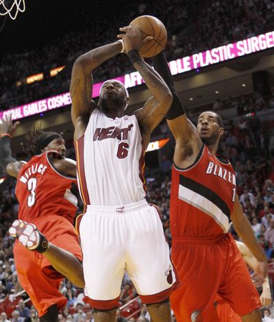 Blazers’ LaMarcus Aldridge blocks shot by Heat’s LeBron James. (Associated Press)