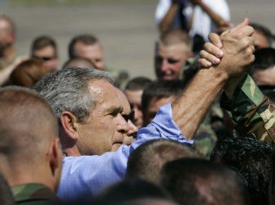 
President Bush clasps hands with a soldier as he greets troops Thursday in New Orleans and thanks them for their service in the hurricane recovery effort. 
 (Associated Press / The Spokesman-Review)