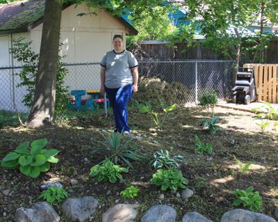 Master Gardener Jennifer Tiegs stands in a shady area of the new landscape she has been designing at her Millwood home.