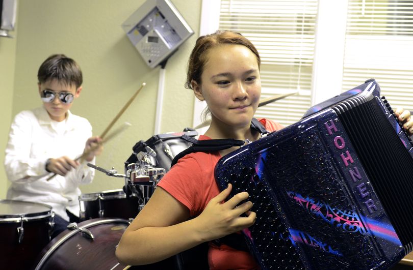 Naomi Harris, 12, right, plays her accordion while rehearsing with the group The Portatos earlier this week at Music City. Playing drums is Sam Tubbs, 12. The group will entertain at the upcoming accordion competition and Harris will compete. (Jesse Tinsley)