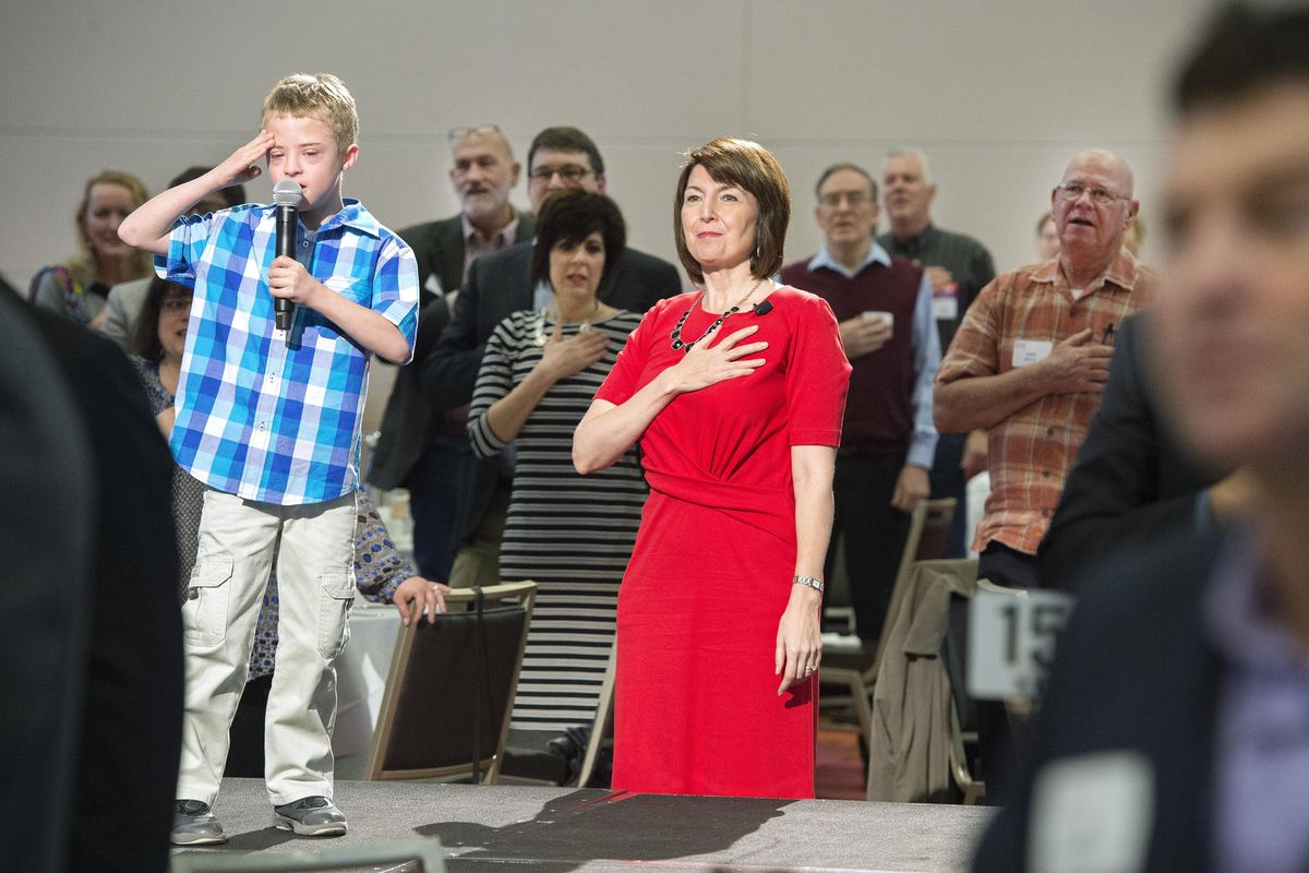 Cathy McMorris Rodgers listens to her son, Cole Rodgers, left, recite the Pledge of Allegiance during her campaign kick off at the Davenport Grand Hotel, March 31, 2016, in Spokane, Wash. (Dan Pelle / The Spokesman-Review)