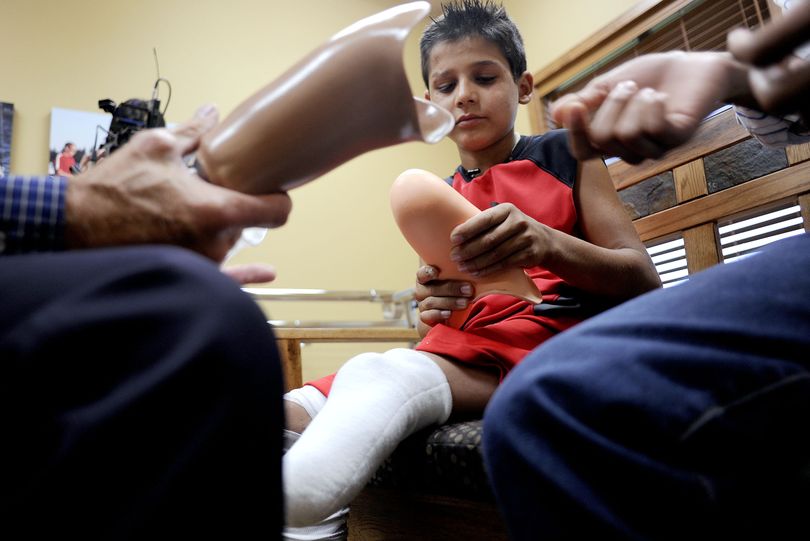 Rahim checks out parts of his new prosthetic leg before being fitted at Kootenai Prosthetics & Orthotics in Post Falls in July. (File)