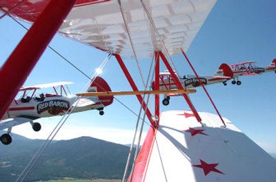 Less than a dozen feet apart, four Stearman biplanes fly in close formation as they bank over Silverwood Theme Park in Athol on Tuesday.
(Jesse Tinsley / The Spokesman-Review)