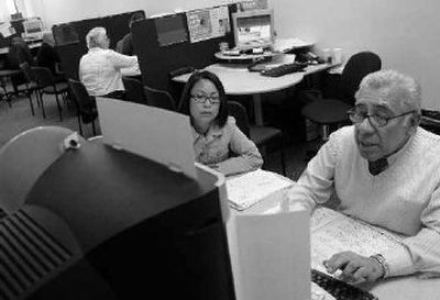H&R Block senior tax advisor Bacho Medina, right, helps JoAn Ramos with taxes at an H&R Block office in San Francisco on Monday.
(Associated Press / The Spokesman-Review)