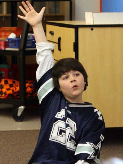 
Third-grader Dylan Wahlmeier raises his hand during class  March 20 at Metzger Elementary in Tigard, Ore. Associated Press
 (Associated Press / The Spokesman-Review)