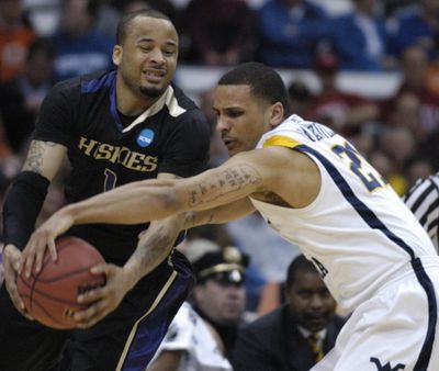 West  Virginia's Joe Mazzulla, right, fights for control of the ball with Washington guard Venoy Overton during the first half of a semifinal in the East Regional of the NCAA college basketball tournament Thursday, March 25, 2010, in Syracuse, N.Y.  (Associated Press)