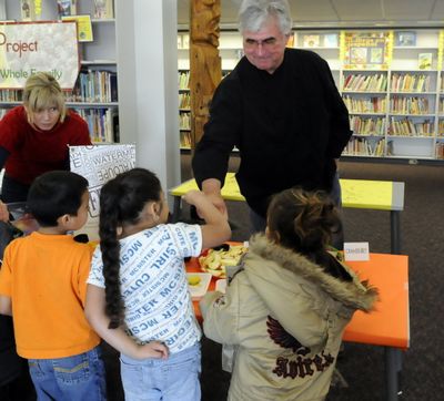 Chef Tom French, with the Experience Food Project, gives a Kindergartner a fist bump during a 